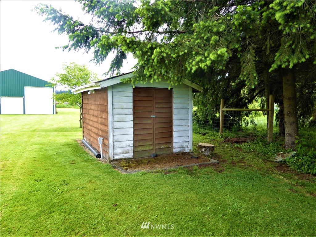 8637 194th Avenue Southwest Rochester, WA 98579 - Photo 4 of 37 a view of a backyard with potted plants and large tree