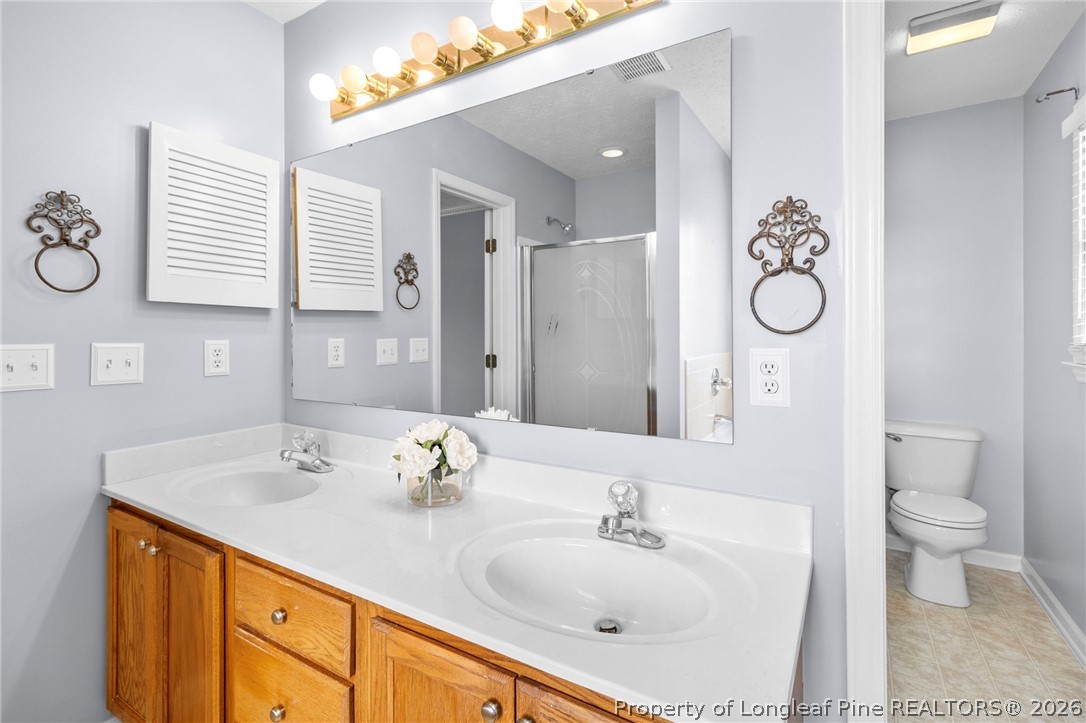 28 Coyt Circle Spring Lake, NC 28390 - Photo 21 of 41 a bathroom with a sink and a mirror