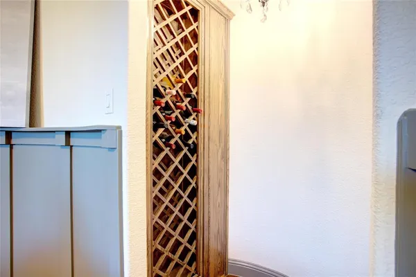 a kitchen with a sink and a large mirror next to a window