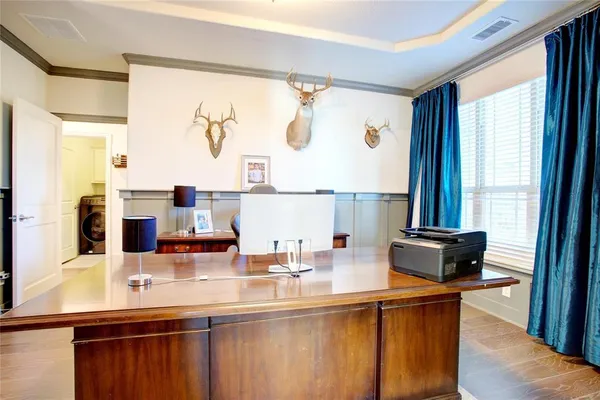 a living room with furniture and a baby crib