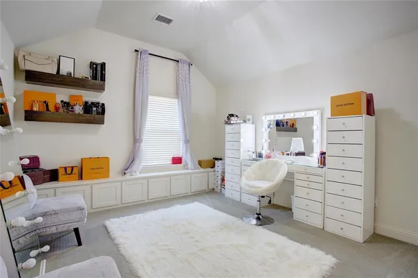 an empty room with chandelier fan and windows