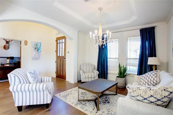a living room with furniture and a chandelier