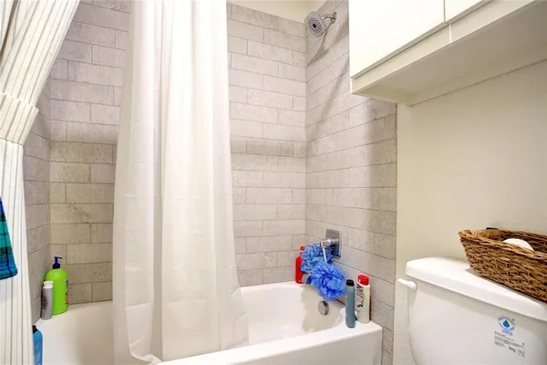 a bedroom with bed and a chandelier