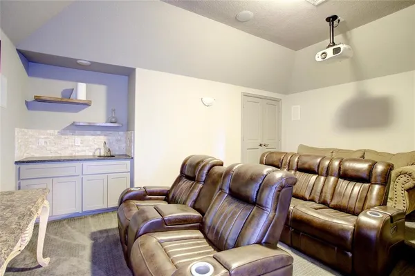 a room with furniture and a projector screen