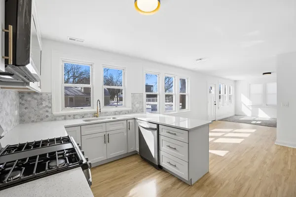 a kitchen with stainless steel appliances granite countertop a stove and a sink
