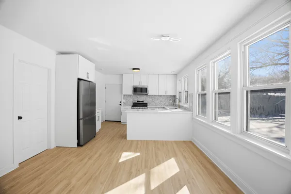 a kitchen with stainless steel appliances a refrigerator and a stove top oven