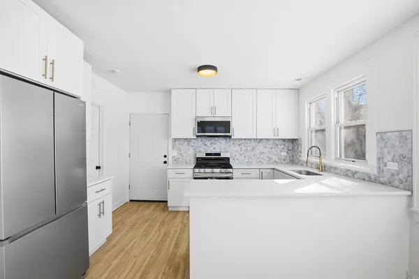 a kitchen with stainless steel appliances granite countertop a stove a sink and a refrigerator