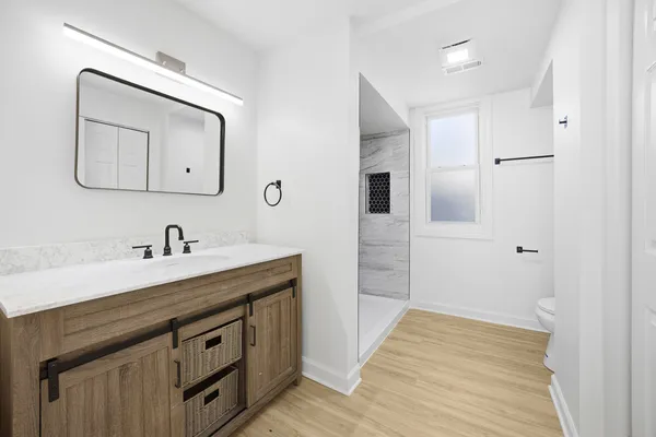 a spacious bathroom with a sink and a mirror