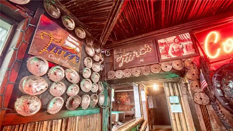 a view of a pathway with a building and a sign on a wall