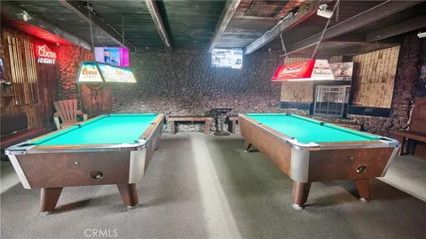 a room with chairs and pool table