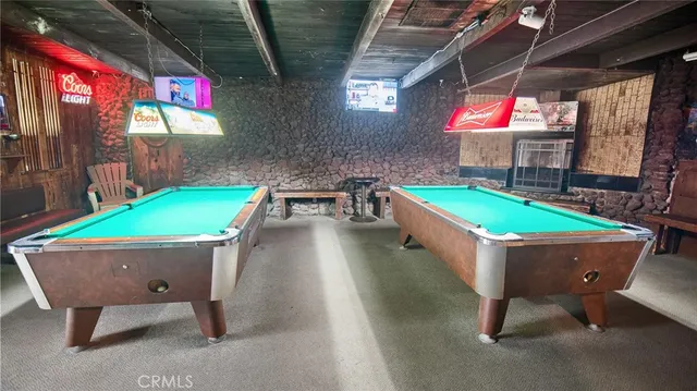 a room with chairs and pool table