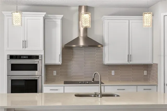 a bathroom with a granite countertop sink a toilet and shower