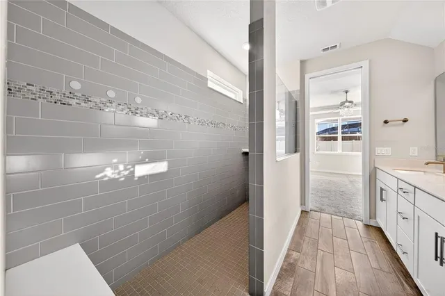 a view of an empty room with wooden floor and stairs