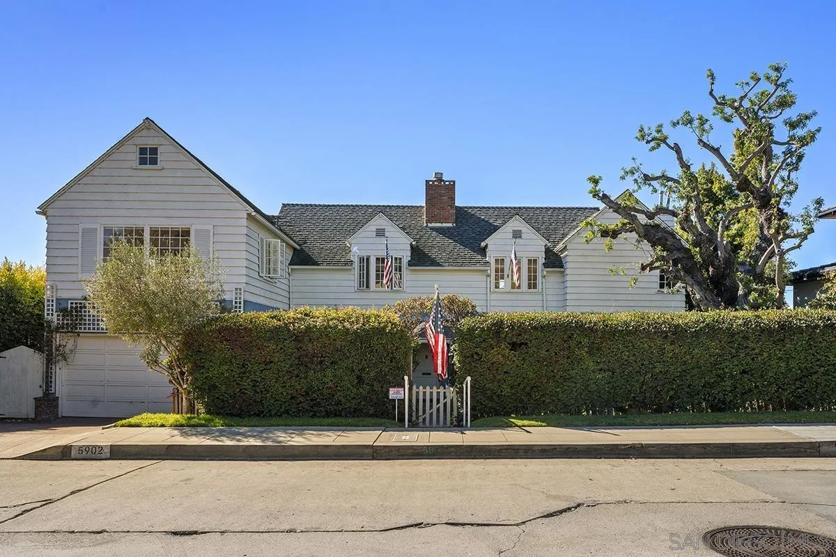 5902 Beaumont Avenue La Jolla, CA 92037 - Photo 2 of 8 a front view of a house with a garden