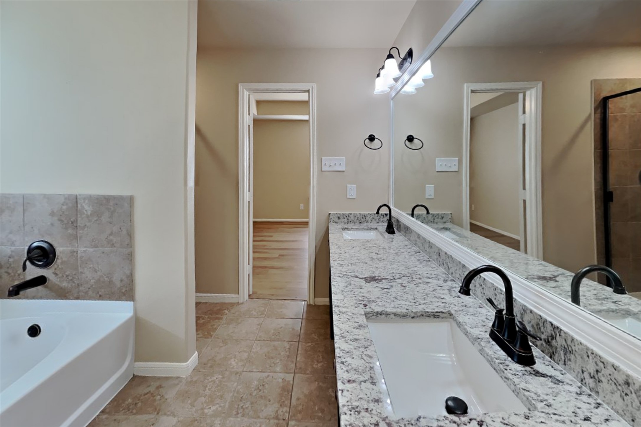 19715 Seabury Path Ct. Katy, TX 77449 - Photo 10 of 20 a bathroom with a sink a faucet a mirror and a bathtub