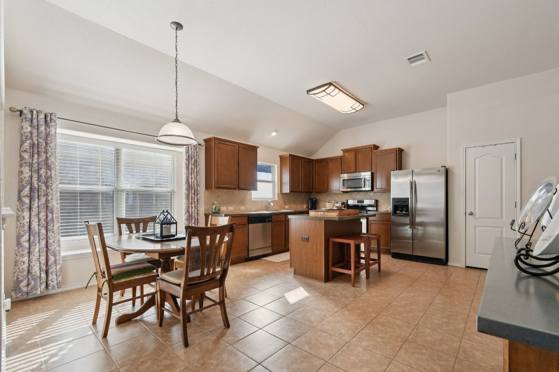 1028 Hot Spring Valley Buda, TX 78610 - Photo 12 of 39 a view of a dining room with furniture window and wooden floor