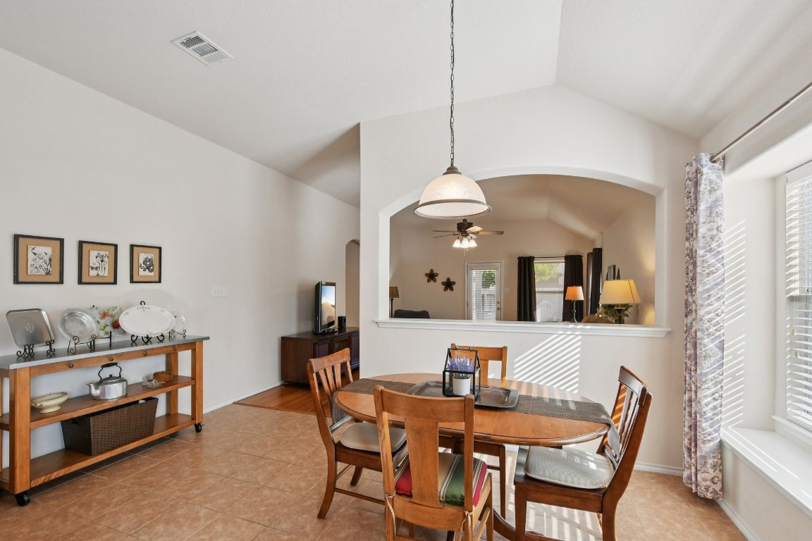1028 Hot Spring Valley Buda, TX 78610 - Photo 13 of 39 a view of a dining room with furniture and chandelier