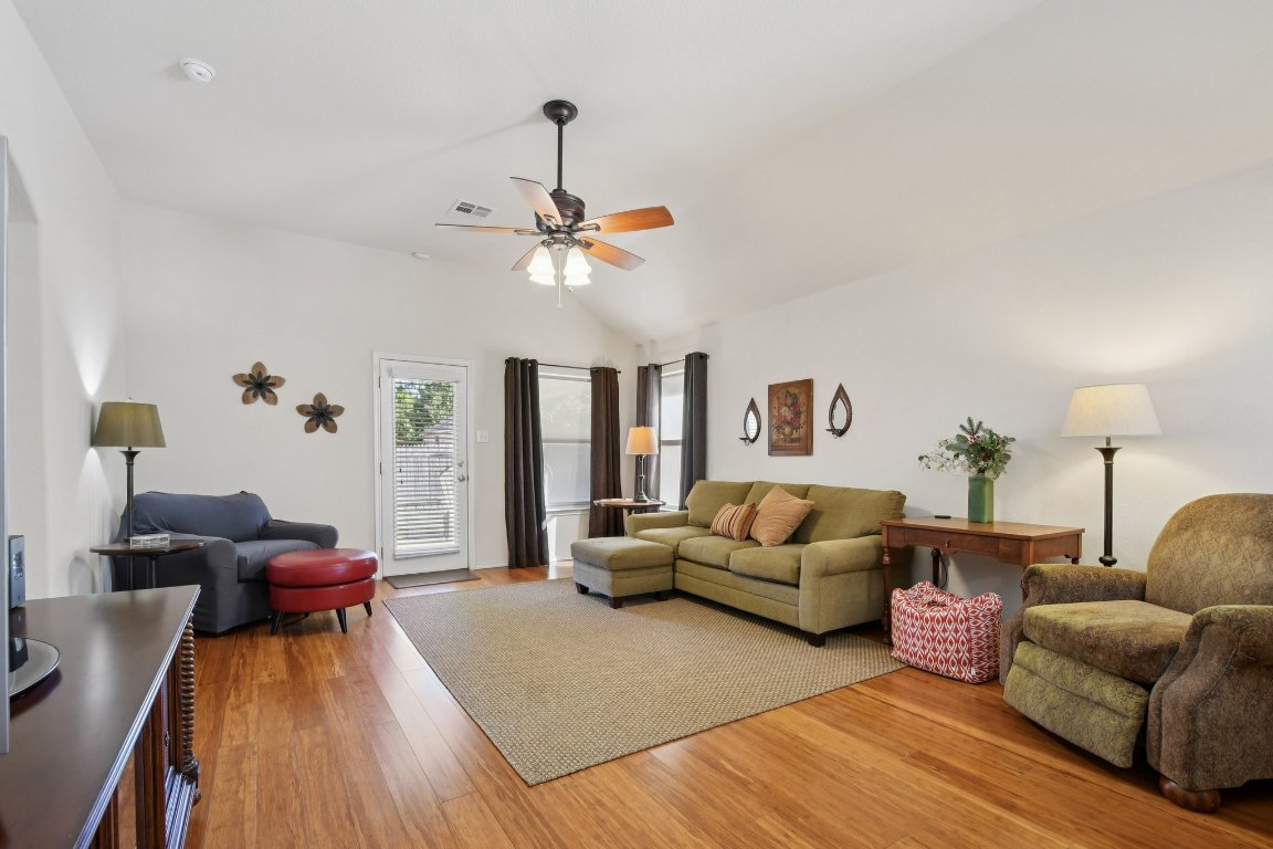 1028 Hot Spring Valley Buda, TX 78610 - Photo 14 of 39 a living room with furniture and a chandelier