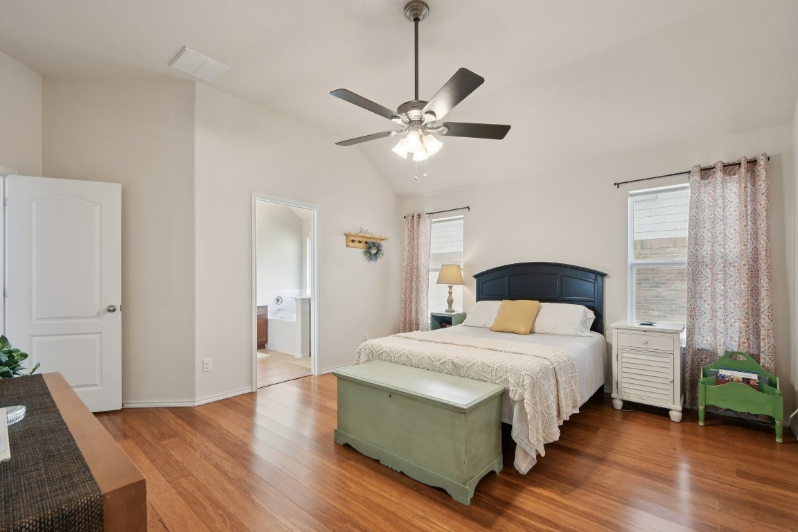 1028 Hot Spring Valley Buda, TX 78610 - Photo 19 of 39 a bedroom with a bed and wooden floor