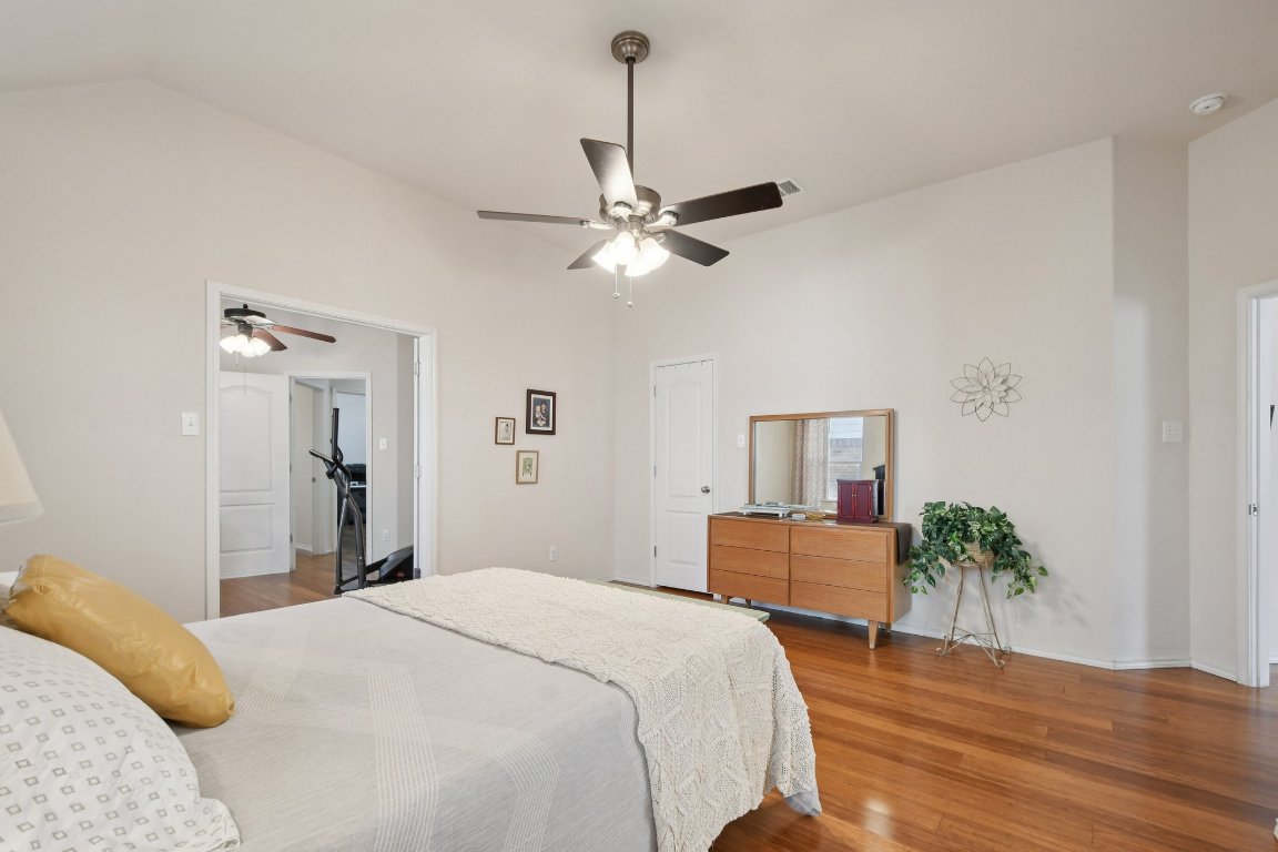 1028 Hot Spring Valley Buda, TX 78610 - Photo 21 of 39 a bedroom with a bed chandelier and a window