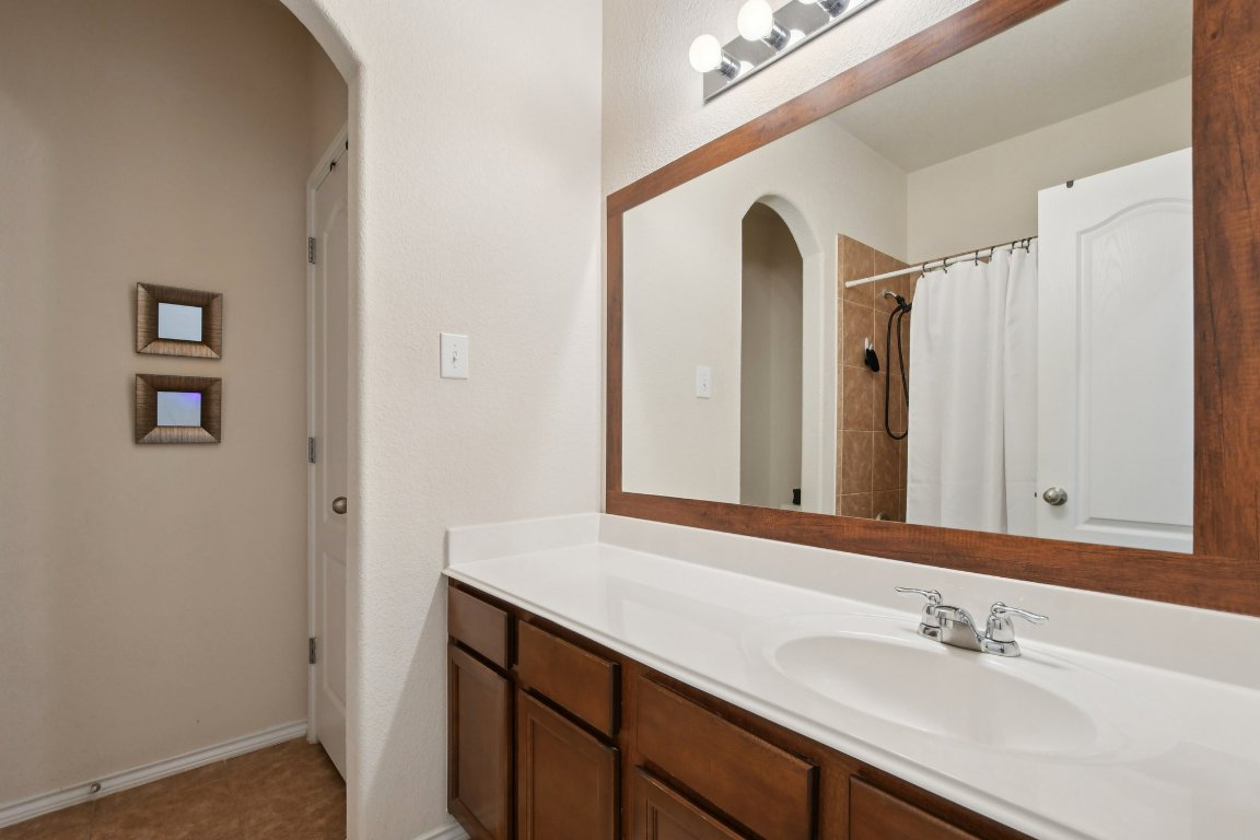 1028 Hot Spring Valley Buda, TX 78610 - Photo 26 of 39 a bathroom with a sink and a mirror