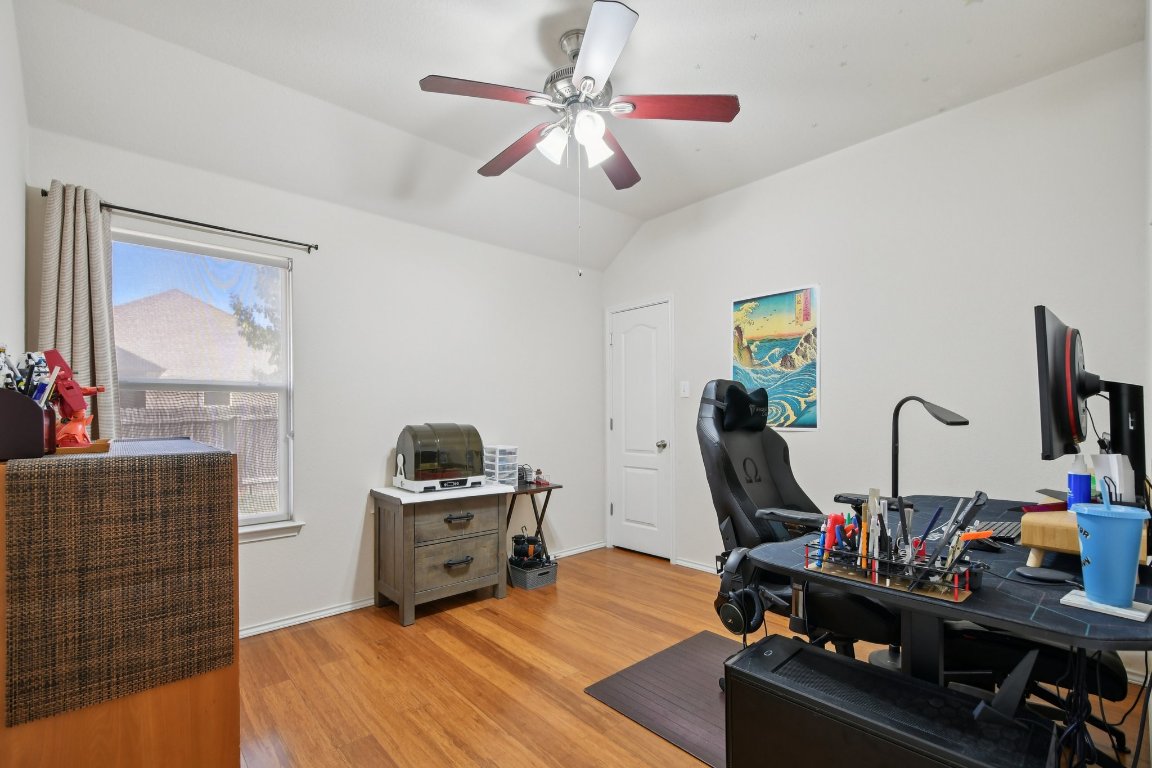 1028 Hot Spring Valley Buda, TX 78610 - Photo 28 of 39 a bedroom with bed and a chandelier