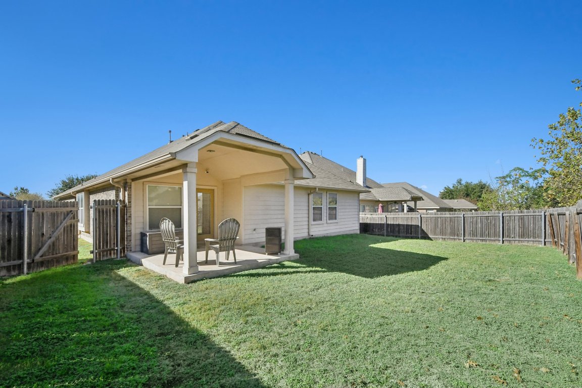 1028 Hot Spring Valley Buda, TX 78610 - Photo 32 of 39 a view of a house with backyard and porch