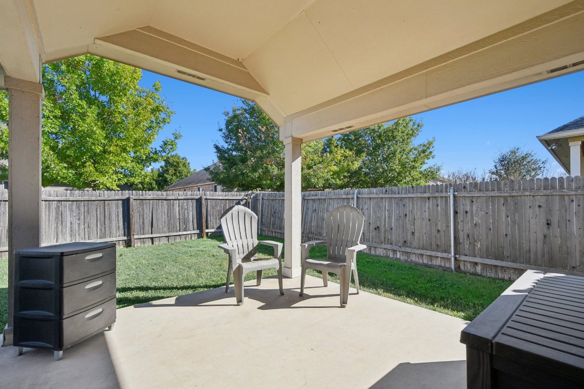 1028 Hot Spring Valley Buda, TX 78610 - Photo 33 of 39 a view of a chair and table in backyard