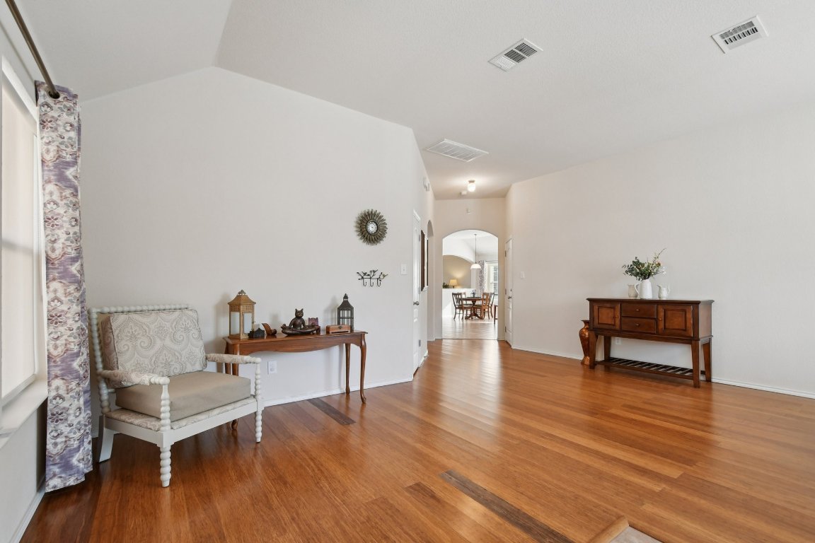 1028 Hot Spring Valley Buda, TX 78610 - Photo 5 of 39 a living room with furniture and a wooden floor