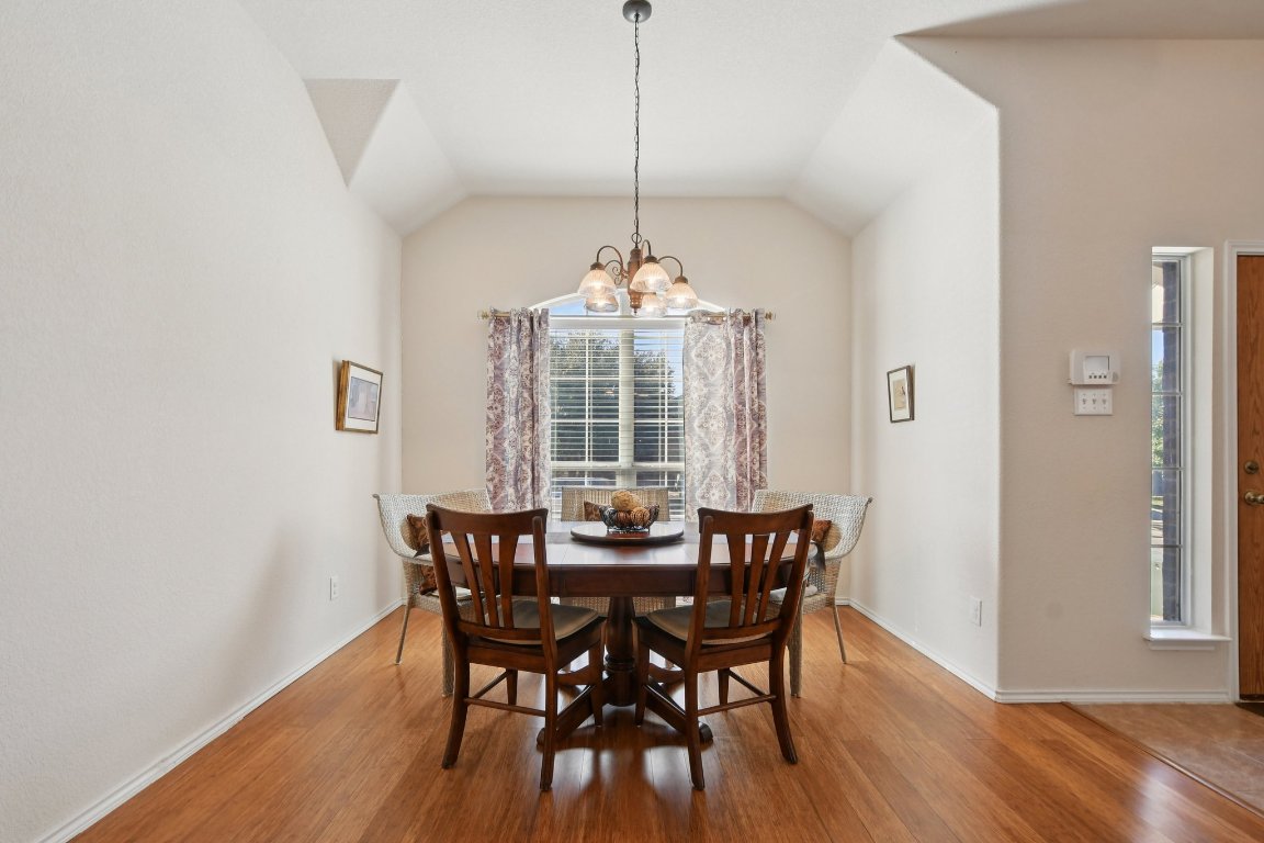 1028 Hot Spring Valley Buda, TX 78610 - Photo 6 of 39 a view of a dining room with furniture window and wooden floor