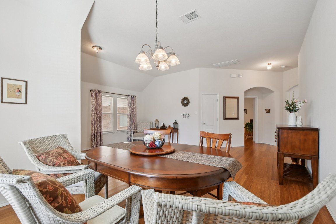 1028 Hot Spring Valley Buda, TX 78610 - Photo 7 of 39 a view of a dining room with furniture and chandelier