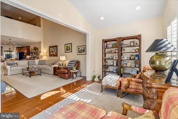a spacious bedroom with two beds and with a large window