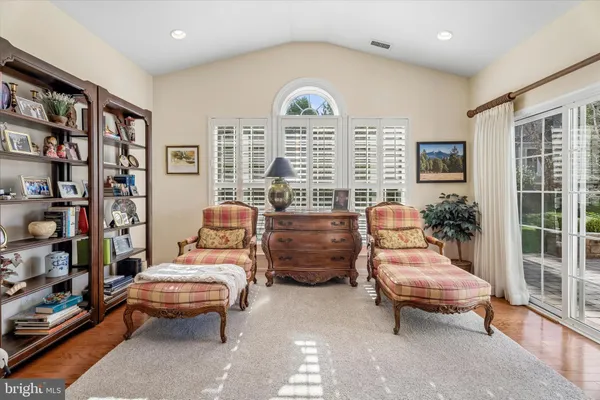 a bedroom with a bed and a tv on the dresser