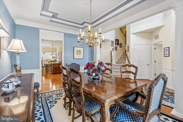 a dining room with furniture and a chandelier