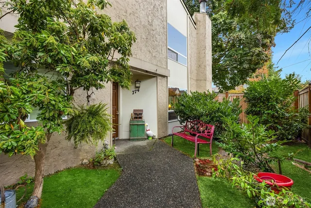 a garden with a bench and some trees