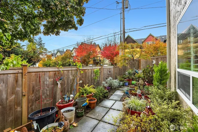 a backyard of a house with barbeque oven table and chairs