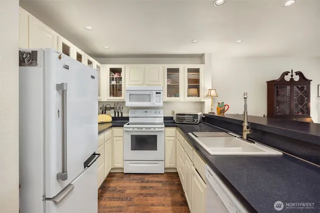 a kitchen with a sink stove and refrigerator