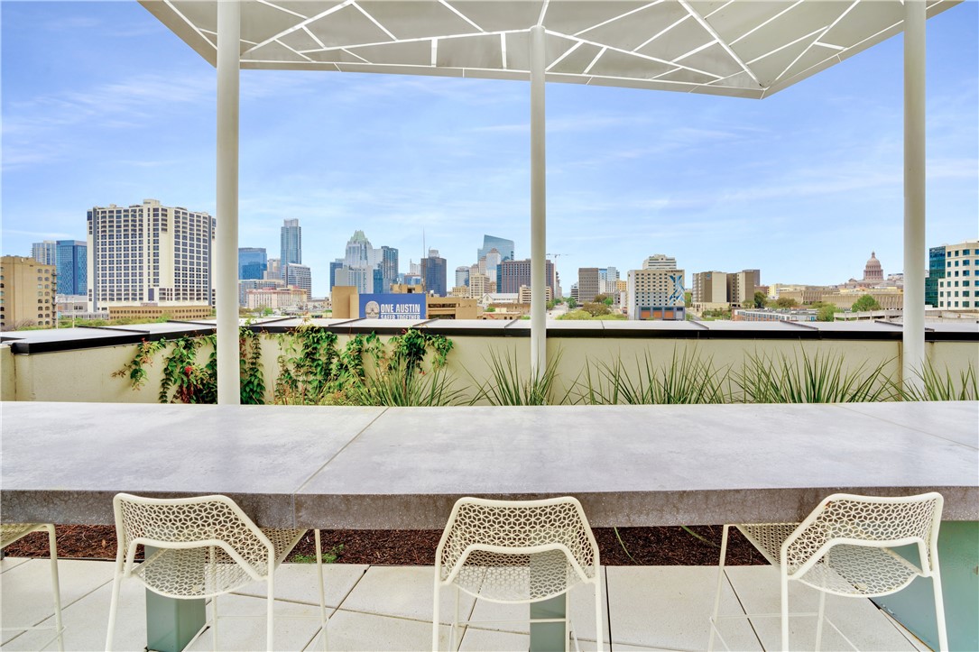 800 Embassy Drive, Unit 227 Austin, TX 78702 - Photo 1 of 1 a terrace with a table and chairs