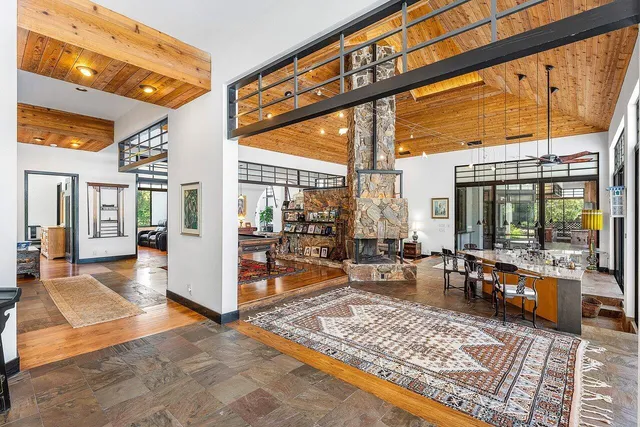 a large bedroom with a large bed and large windows