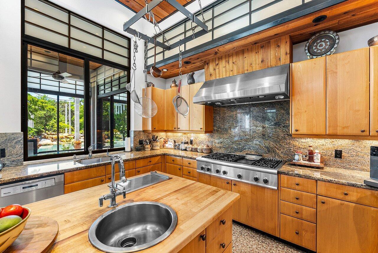 8549 Surrey Lane Boca Raton, FL 33496 - Photo 19 of 106 a kitchen with a sink and a stove next to a window