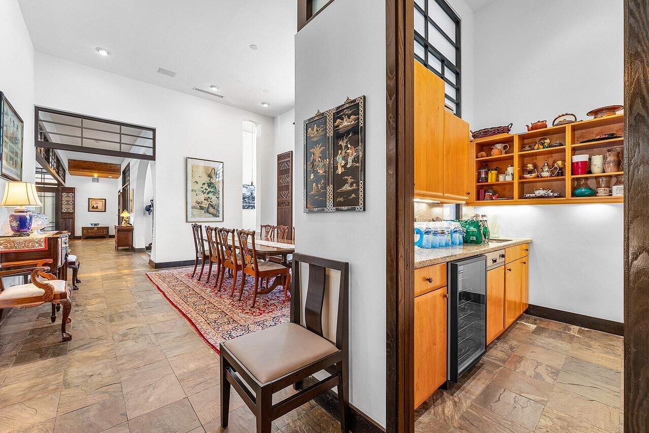 8549 Surrey Lane Boca Raton, FL 33496 - Photo 22 of 106 a open kitchen with stainless steel appliances granite countertop a stove a refrigerator a dining table and chairs with wooden floor