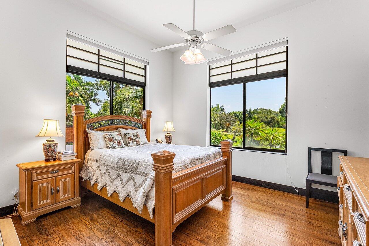 8549 Surrey Lane Boca Raton, FL 33496 - Photo 24 of 106 a bedroom with a bed and a chandelier