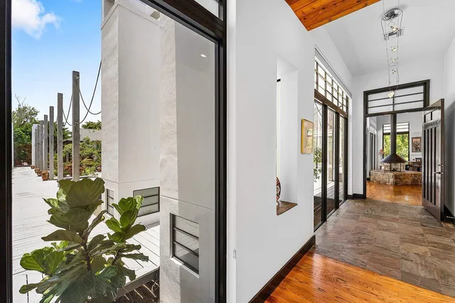 a view of a swimming pool with a table and chairs under an umbrella