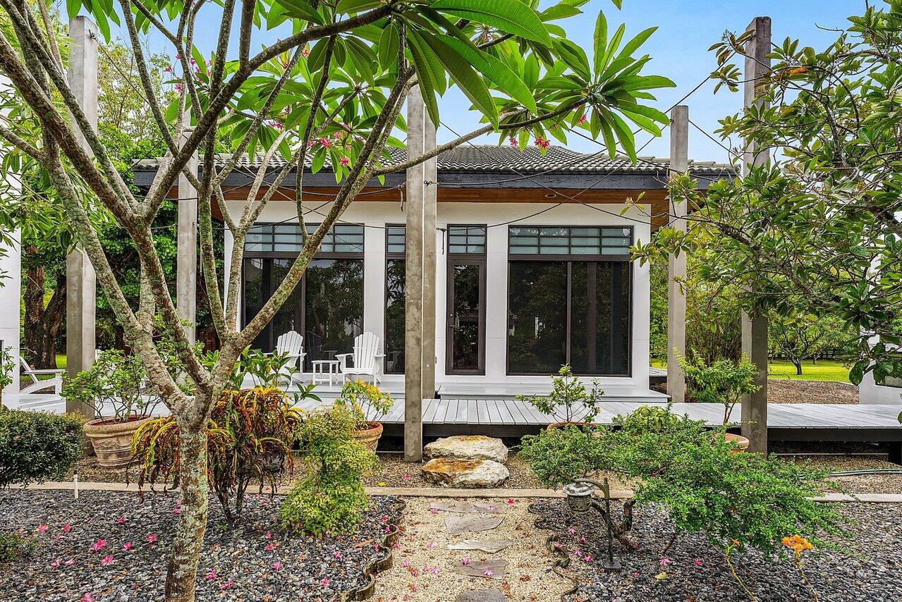 8549 Surrey Lane Boca Raton, FL 33496 - Photo 40 of 106 a front view of a house with garden
