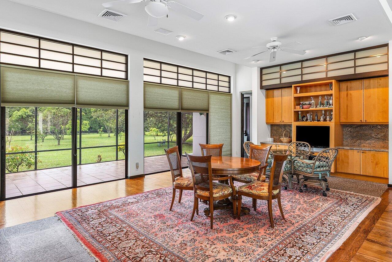8549 Surrey Lane Boca Raton, FL 33496 - Photo 57 of 106 a view of a dining room with furniture window and wooden floor