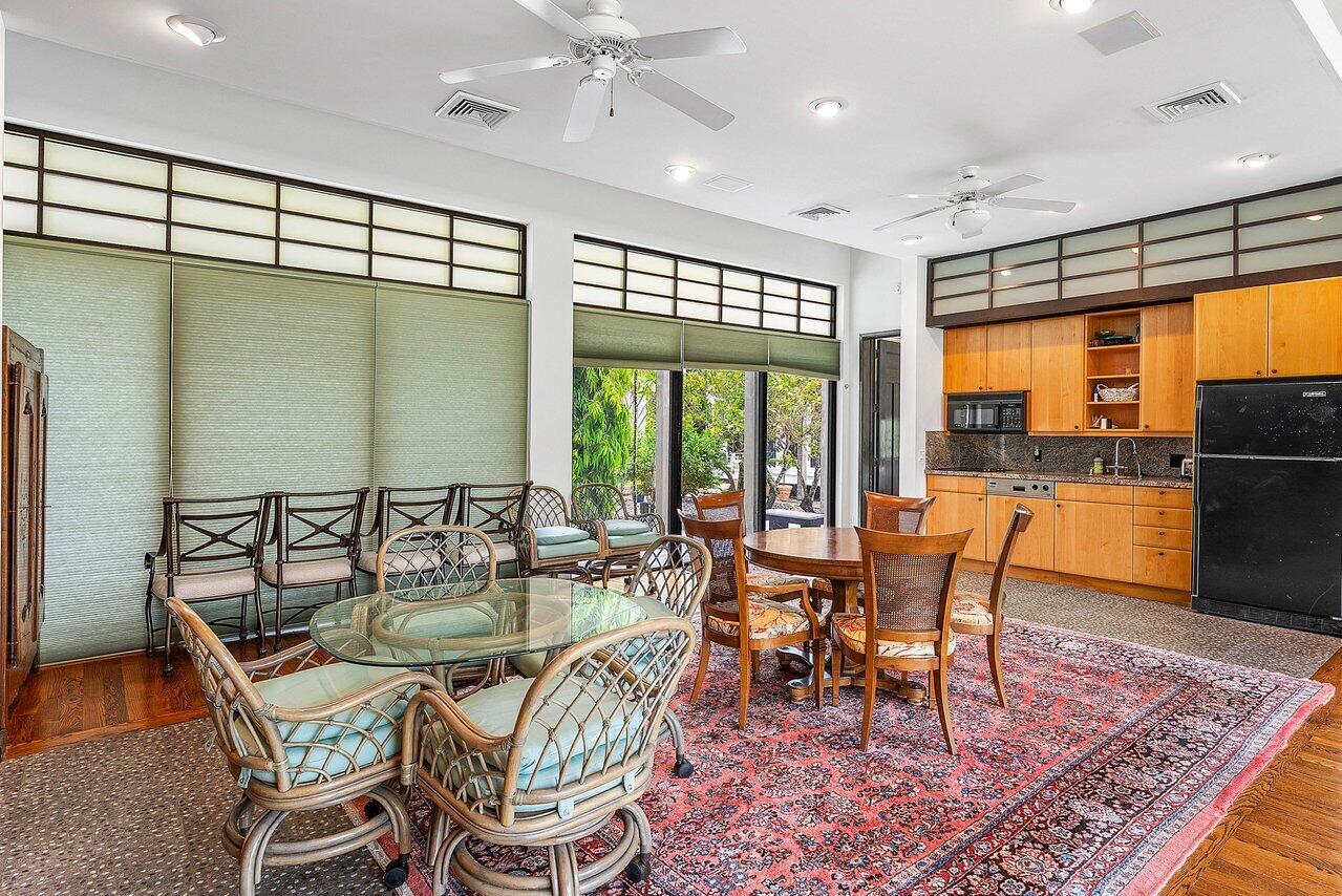 8549 Surrey Lane Boca Raton, FL 33496 - Photo 58 of 106 a dining room with furniture a rug and a floor to ceiling window