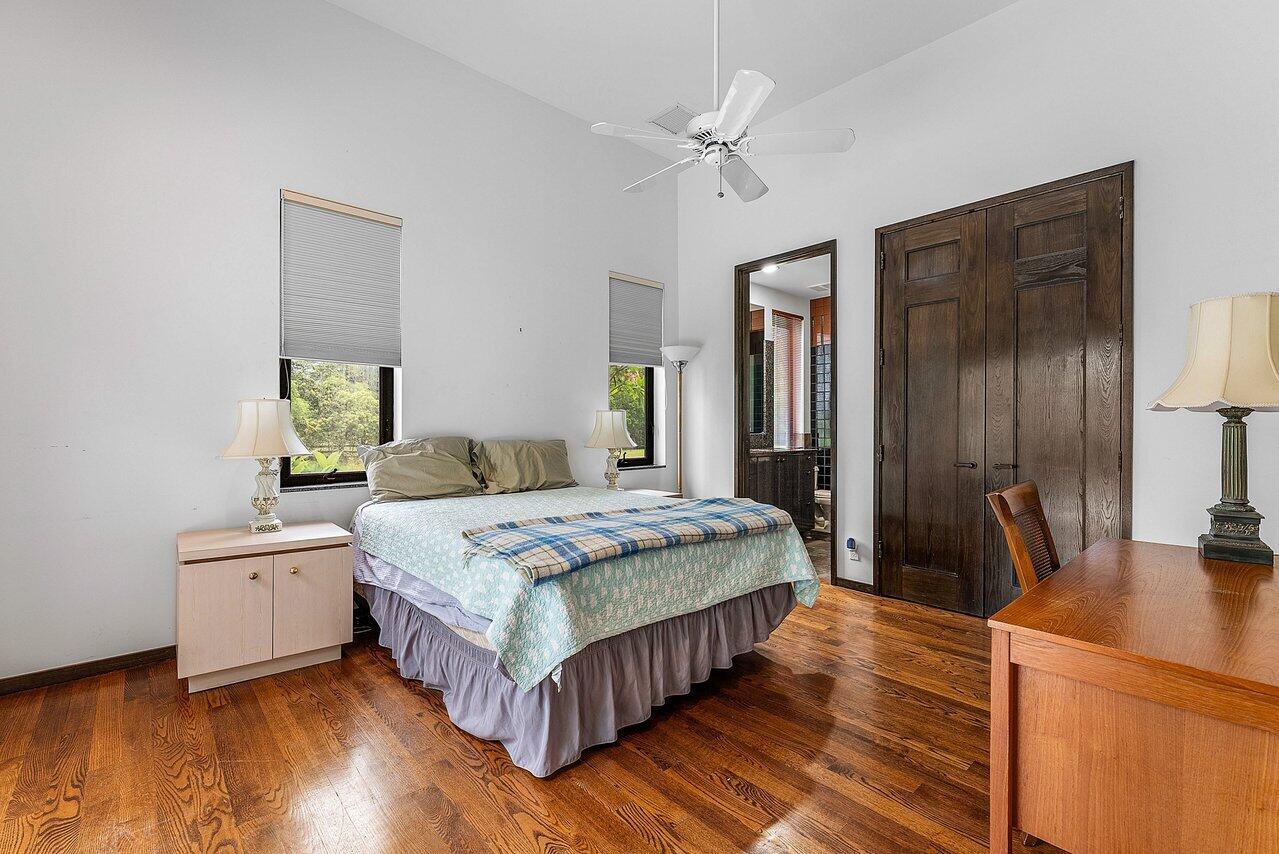 8549 Surrey Lane Boca Raton, FL 33496 - Photo 62 of 106 a bedroom with a bed and wooden floor