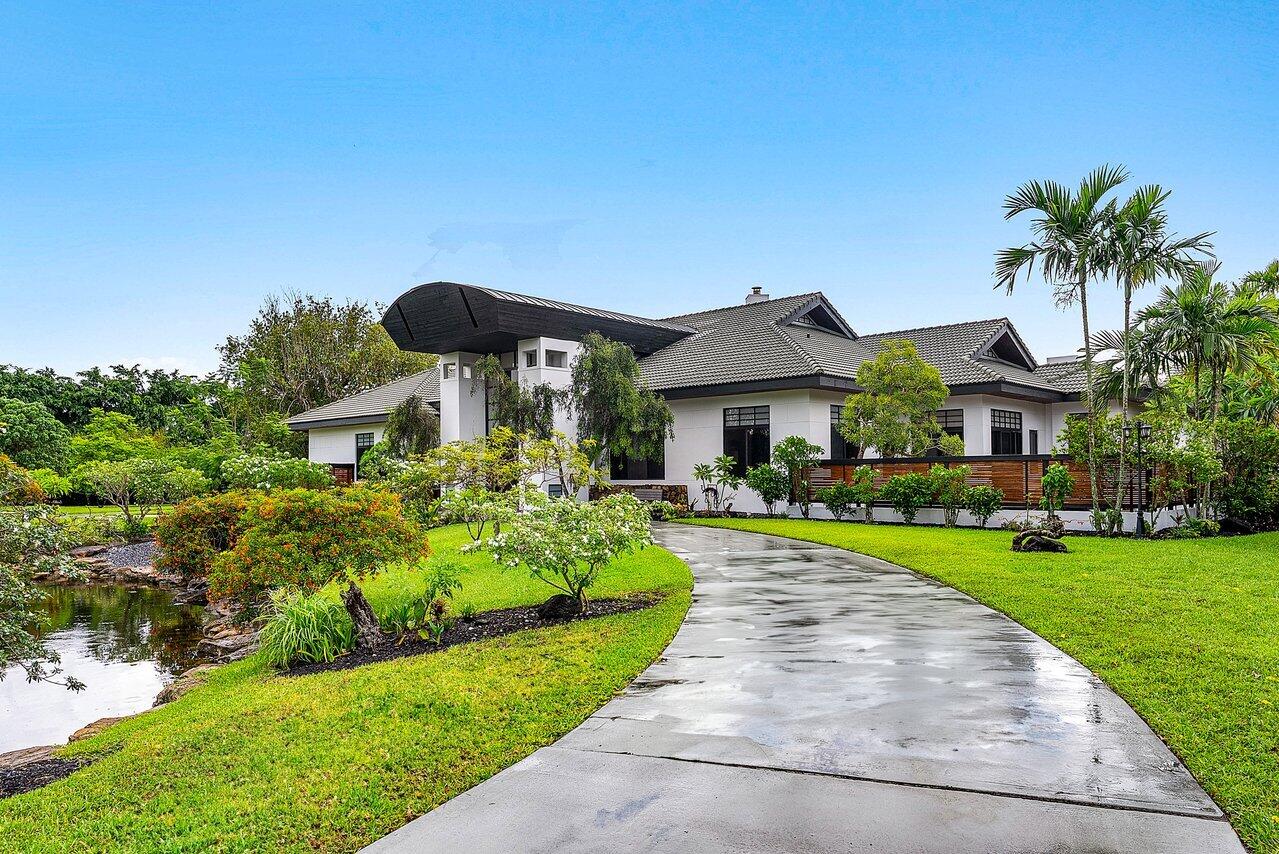 8549 Surrey Lane Boca Raton, FL 33496 - Photo 85 of 106 a front view of house with yard and green space