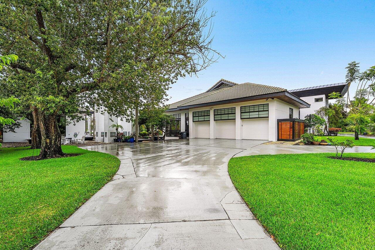 8549 Surrey Lane Boca Raton, FL 33496 - Photo 86 of 106 a front view of a house with a yard