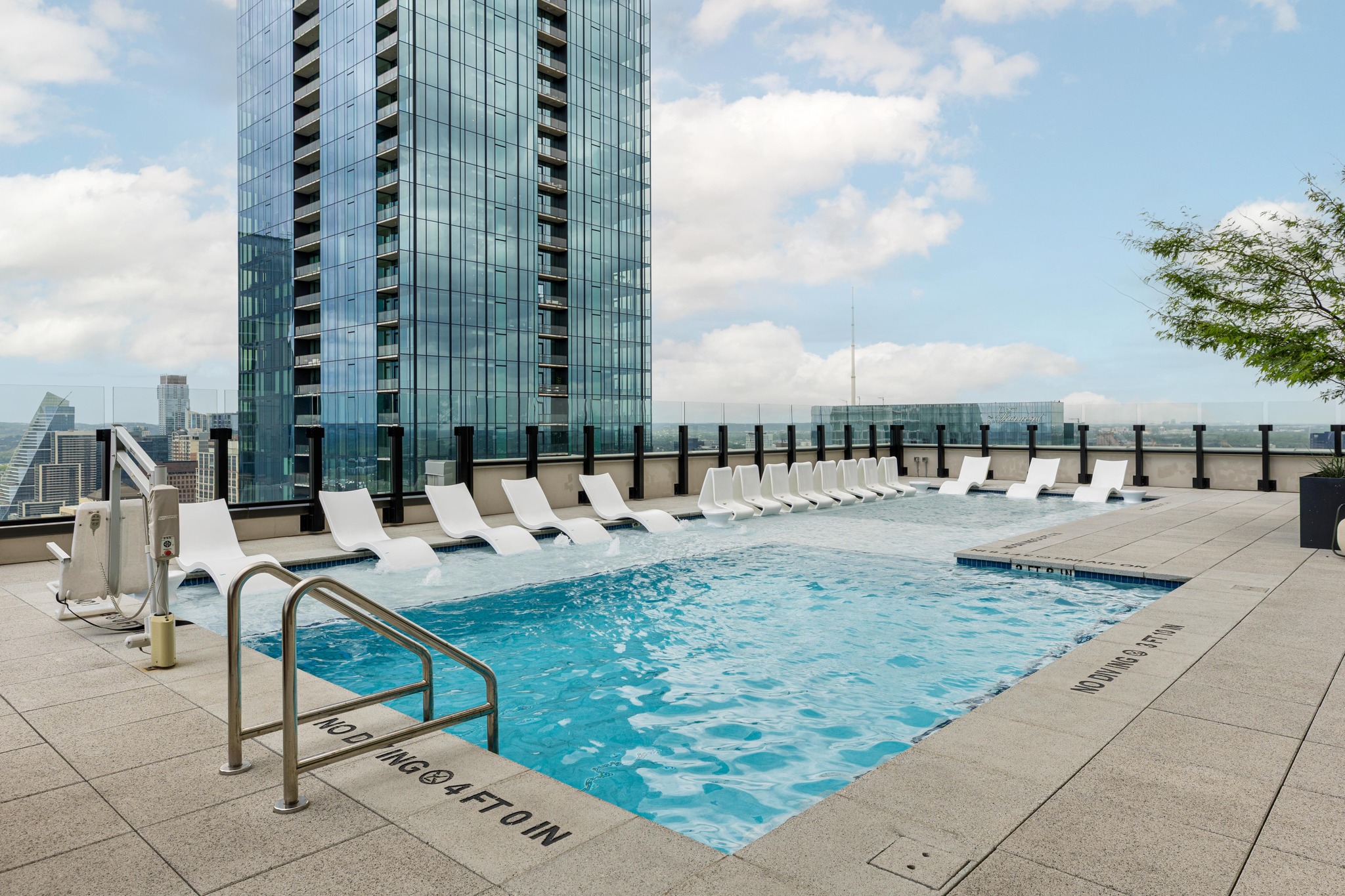 84 East Avenue, Unit 2008 Austin, TX 78701 - Photo 4 of 23 Rooftop deck features a sleek pool with integrated lounge seating and city skyline views.